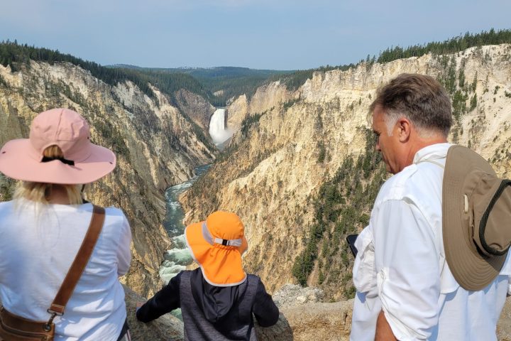 a couple of people that are standing in front of a mountain