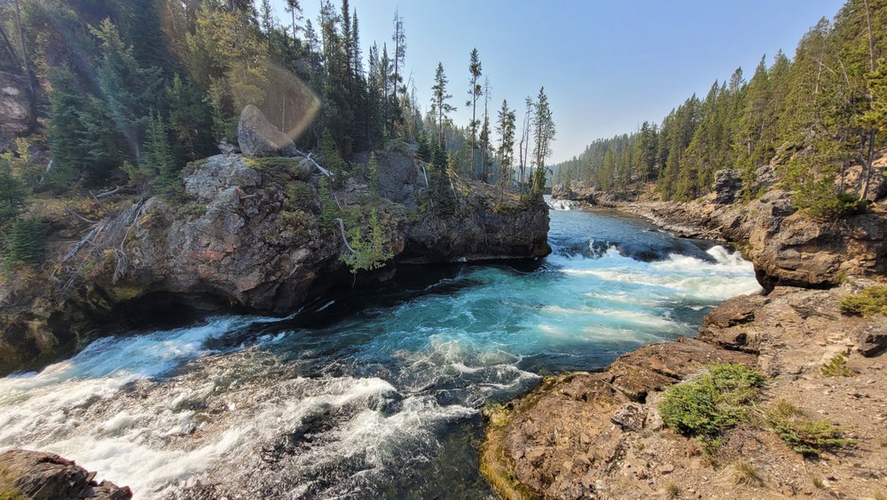 a large waterfall over a body of water