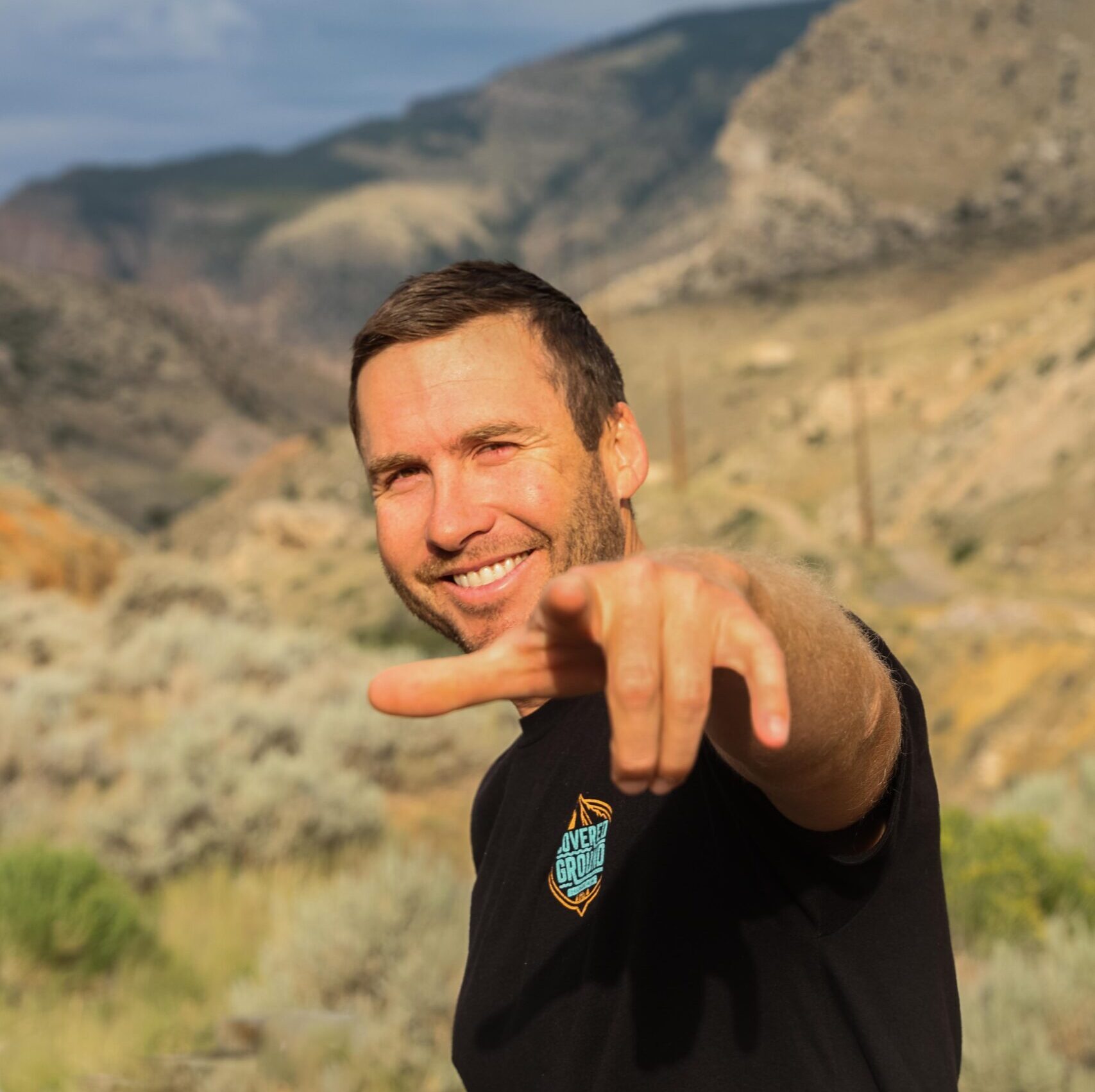 a man standing in front of a mountain